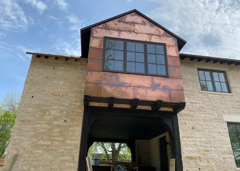 Copper metal panel facade on a stone building for Metal Roof Coating in Reno