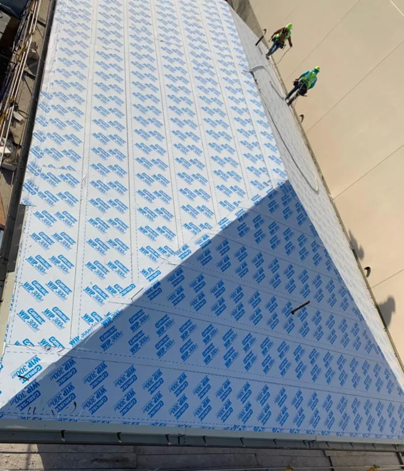 Professional roofers installing underlayment on a metal roof in Reno